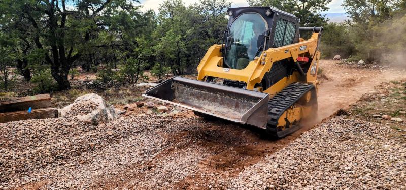 CAT skid steer grading terrain in Crestone, Colorado