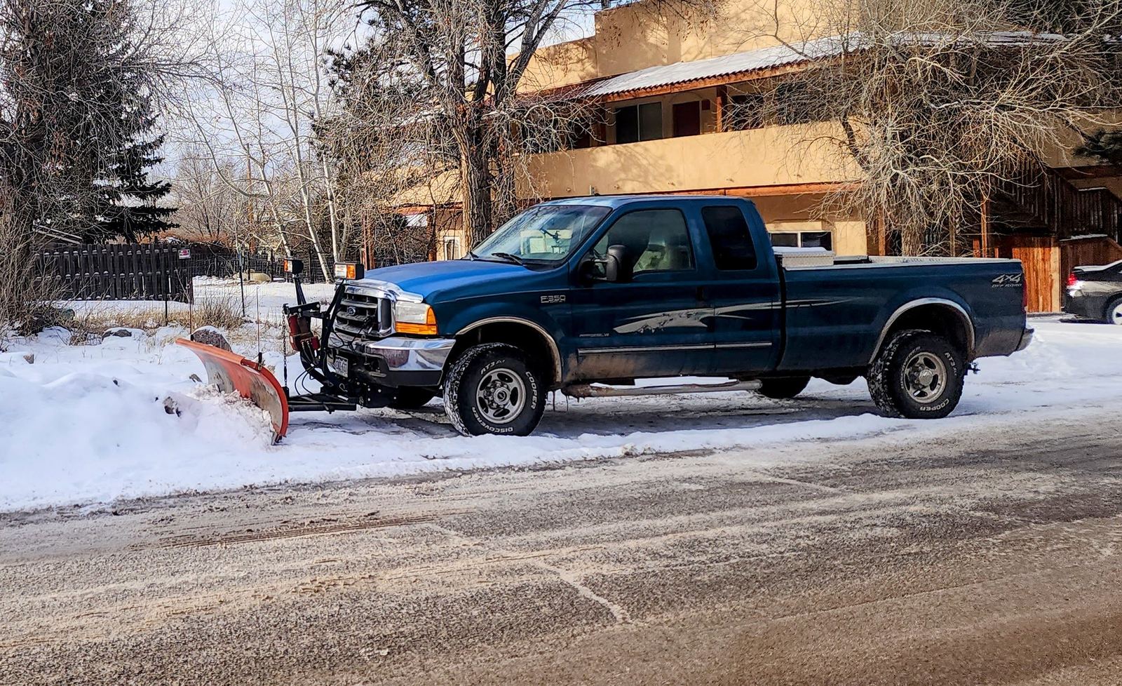 Ford F-350 with a plow on a freshly cleared street in Crestone, Colorado